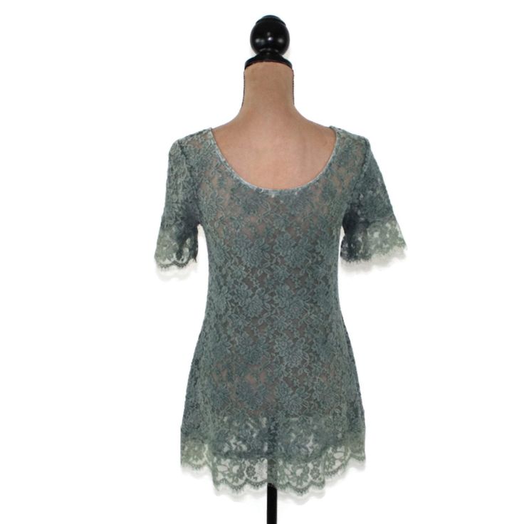 This teal green lace top has a romantic boho vibe. The blouse has a scoop neck, short sleeves and is sheer. The blouse has feminine eyelash lace embellishments on the sleeve and hemline and can be styled in so many ways. Each piece in our HEART ALTERED collection has been embellished with our signature ♥ charm. 50% cotton, 50% polyester Hand wash, hang dry. Measurements: Small ~ Between shoulder seams ~ 14 inches Bust ~ 34 inches Waist ~ 33 inches Length from top of shoulder to bottom of the dre Bohemian Spring Lace Top With Short Sleeves, Bohemian Short Sleeve Lace Top For Spring, Summer Lace Patchwork Short Sleeve Top, Fitted Scalloped Lace Short Sleeve Blouse, Fitted Scalloped Lace Short Sleeve Top, Short Sleeve Crochet Top With Lace Patchwork For Spring, Fitted Bohemian Crochet Crew Neck Top, Fitted Tops With Delicate Lace And Short Sleeves, Lace Patchwork Short Sleeve Top