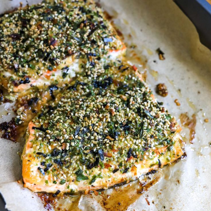 two pieces of food that are on top of some parchment paper with sprinkles