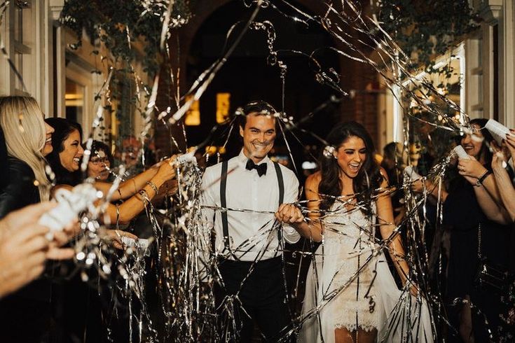 a group of people standing next to each other with streamers in front of them