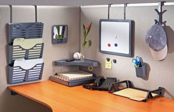 a wooden desk topped with lots of office supplies