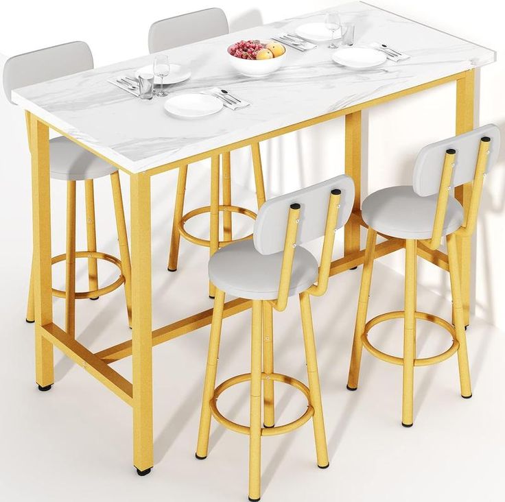 a table with four stools and plates on the counter top, in front of a white wall