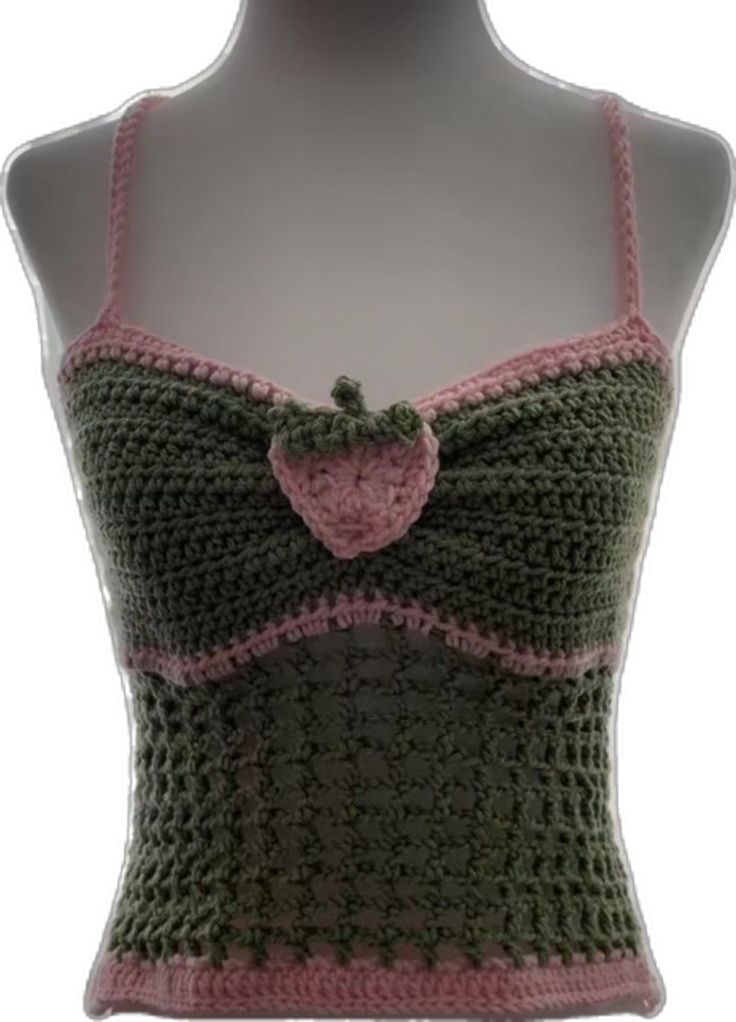 a crocheted tank top on a mannequin's head with a pink bow