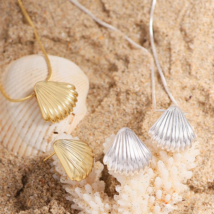 Description & Details Embrace the beauty of the sea with our meticulously crafted pieces that capture the essence of shells in stunning detail. From elegant shell-shaped pendants to intricate shell-inspired necklaces, our collection offers a range of styles to suit your unique taste. • Material: Solid 925 Sterling Silver • Finish: Hypoallergenic ∙ Gold Plating• Dimensions: 17.3 mm pendant, 40 - 45 cm chain, adjustable• All our work is custom made by hand with love Elegant Silver Necklace For Beach, Shell Necklace With Clavicle Chain As Gift, Shell Necklace With Clavicle Chain For Gift, Gift Shell Necklace With Clavicle Chain, Beach Shell-shaped Necklace With Clavicle Chain, Shell-shaped Clavicle Chain Necklace For Beach, Silver Shell-shaped Jewelry, Shell Clavicle Chain Jewelry, Clavicle Chain Shell Necklace For The Beach