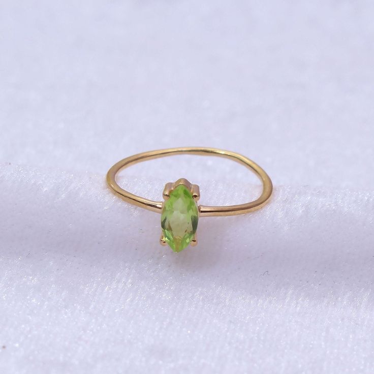 "Materials Gold, Rose gold, White gold Gemstone: Natural Peridot Peridot Ring / 14k Gold Peridot Wedding Ring / Anniversary Ring / Marquise Ring / Stacking Ring / Dainty Ring / Gemstone Ring / Prong set Item Details * Made to Order * Material: 14K Solid Gold (If 18K is needed, please inquire) * Gold Color Choice: Rose Gold, Yellow Gold, White Gold * Total CTW: .50 crt( 4 mm) (varies by size of the ring) * Width of Band: 1.30mm Ready to Ship in 7-10 Business Days * Also available in other gemston Gold Stackable Rings With Peridot Birthstone, Dainty Peridot Promise Ring, Dainty Peridot Ring For Gift, Dainty Peridot Ring Gift, Fine Jewelry Peridot Rings For May Birthstone, Peridot Gemstone Stackable Rings As Gift, Yellow Gold Peridot Diamond Ring With Birthstone, Gift Yellow Gold Peridot Gemstones, Stackable Yellow Gold Peridot Jewelry