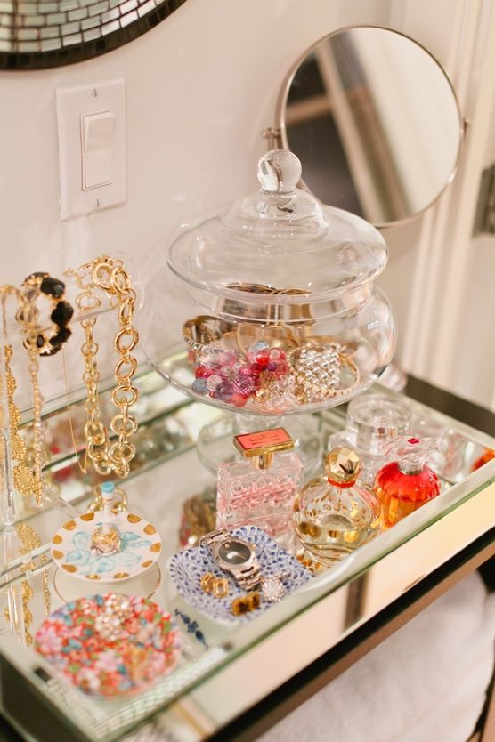 an assortment of jewelry is displayed on a glass shelf