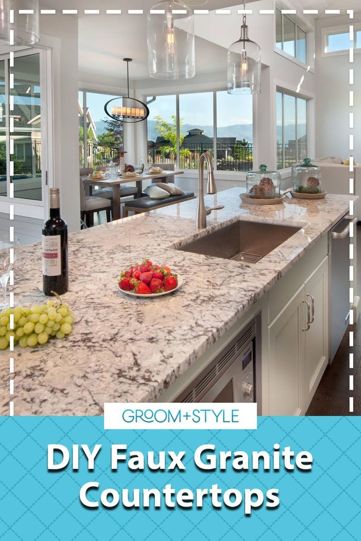 a granite counter top in a kitchen with wine bottles and fruit on the countertop