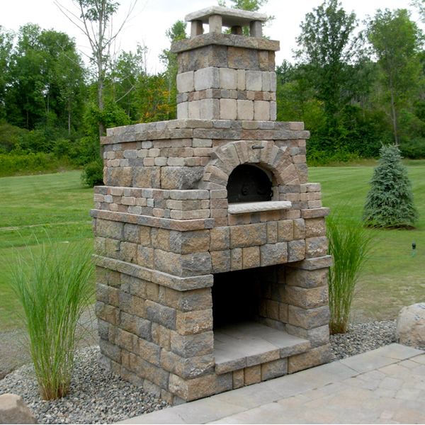 a brick oven sitting in the middle of a park