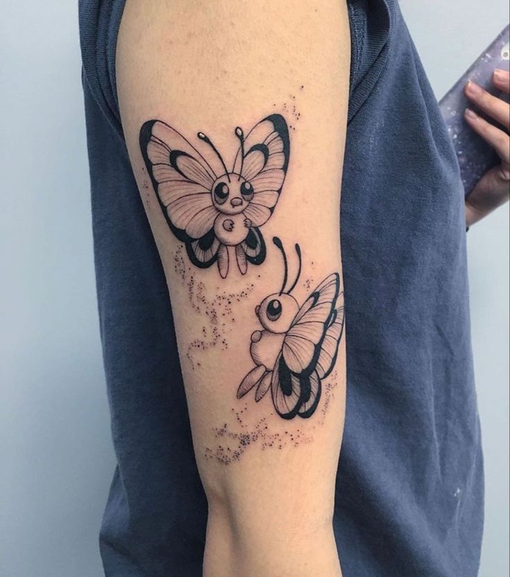 a woman's arm with two butterflies and stars on the back of her body