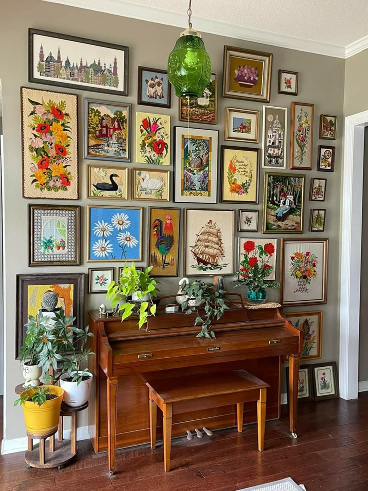 a living room filled with lots of framed pictures on the wall above a grand piano