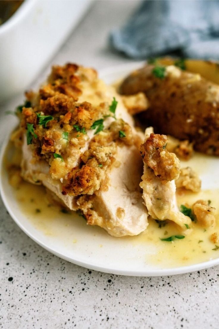 a white plate topped with chicken covered in gravy