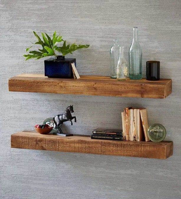 two wooden shelves with books and plants on them