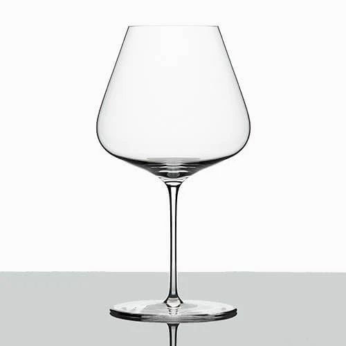 an empty wine glass sitting on top of a table