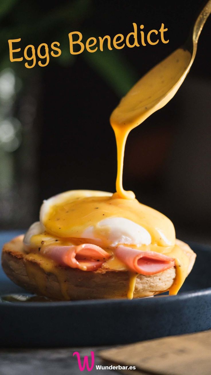 an egg benedict is being drizzled with mustard