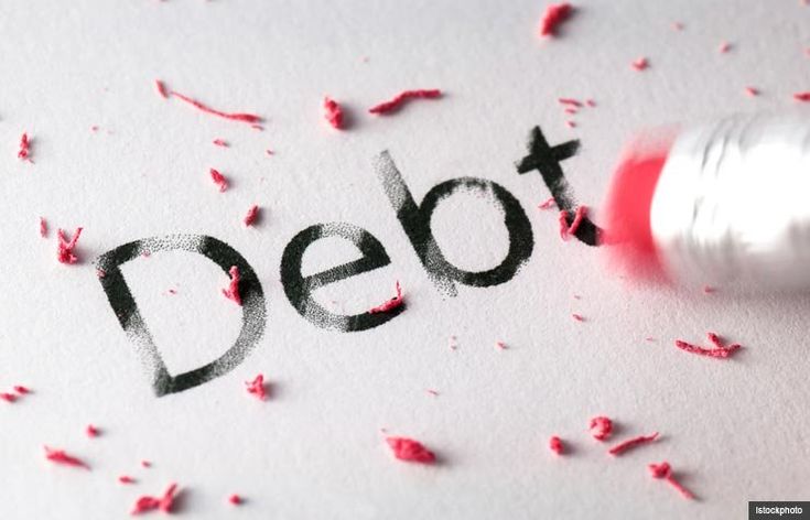 the word debt written in black and red ink on a piece of paper