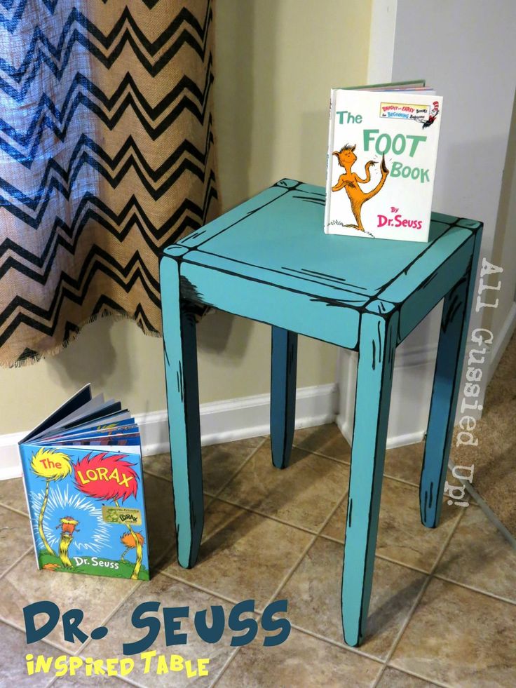 a small blue table with a book on it and a dr seuss book in front of it