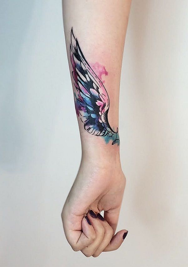 a woman's arm with a bird tattoo on it