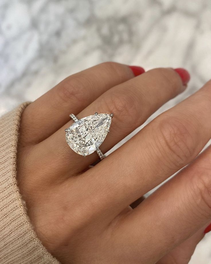 a woman's hand with a diamond ring on it