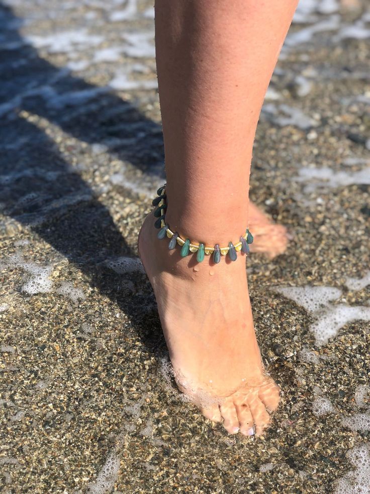 ✨🌸 Add a Touch of Elegance with Our Green Drop Crystal Beaded Anklet!  🌸✨ Step into style with our Green Drop Crystal Beaded Anklet, a dazzling accessory that brings a splash of sparkle to your steps! Perfect for dressing up your ankles, this anklet features stunning crystals that catch the light and add a touch of glamour to any outfit. Whether you're at the beach, a party, or just enjoying a sunny day, this anklet is your go-to for effortless charm. 🔮 Features: 💎 Glistening Crystals: Adorn Gold Beaded Bracelets For Summer Parties, Summer Party Ankle Wrap Bracelet, Summer Party Beaded Bracelets With Tiny Beads, Flexible Beaded Anklets For The Beach, Summer Party Tiny Beaded Bracelets, Summer Party Tiny Beads Bracelet, Multicolor Beaded Anklets For Party, Adjustable Beaded Bracelets For Summer Party, Adjustable Beaded Anklets With Ankle Strap