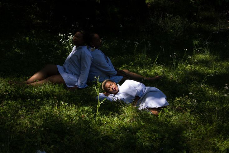 two people are laying in the grass near each other