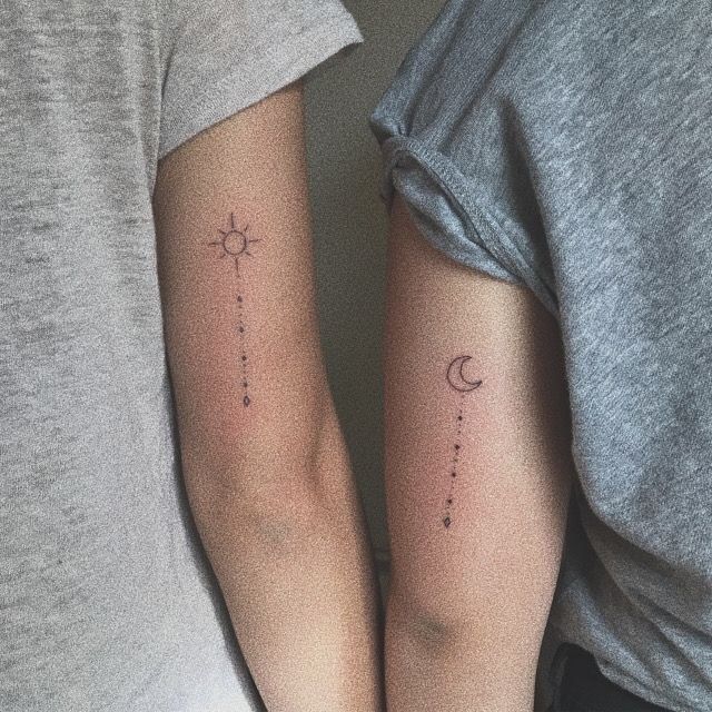 two people with tattoos on their arms and one has a sun and moon tattoo on the arm