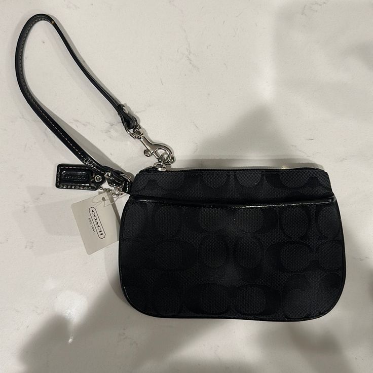 Coach Signature Small Wristlet. Brand New, Never Worn With Tags. Sv/Black Grey/Black. Mostly Just Black With A Grey Interior. Make An Offer. Black Clutch Wallet With Wrist Strap, Black Zipper Pouch Wristlet For Travel, Black Rectangular Wristlet With Zipper Closure, Coach Black Wristlet With Zipper Pouch, Black Pouch Wristlet With Zipper Closure, Black Handheld Clutch With Zipper Closure, Black Pouch Wristlet With Wrist Strap, Black Zipper Pouch Wristlet, Black Clutch Wristlet For Formal Occasions