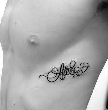 a man's chest with the word love tattooed on his left side ribcage