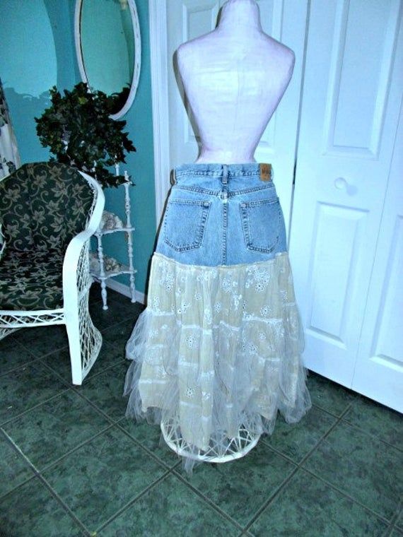 "This \"Belle Bohémienne\" jean skirt is one of my line of Renaissance Denim Couture, the name I chose for my line of couture because I take vintage denim and give it new life with French bohemian flair. To make this Renaissance Denim couture, I took an authentic pair of vintage 1970's GAP jeans and upcycled them by adding an exquisite vintage Marrika Nakk skirt that has lots of layers of gorgeous, exquisite, antique eyelet lace and soft bridal tulle in beautiful golden beige and ceam The waist Cowgirl Mermaid, Fairy Cowgirl, Denim Couture, French Bohemian, Lace Jeans, Rose Jeans, Church Fits, Fairy Festival, Boho Fairy