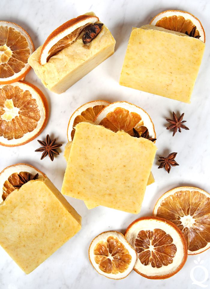 orange slices and star anise soap on a white marble counter top with cinnamons