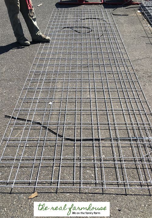 a man standing next to a metal grate on the ground