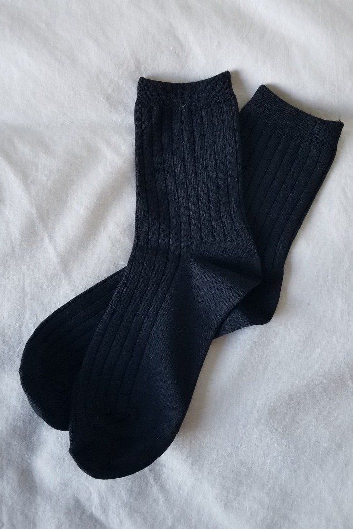 Le Bon Shoppe Her socks perfect height knit rib socks. 98% nylon, 2% spandex. one size fits most. Machine wash cold, tumble dry low. PIPE AND ROW Black Stretch Socks For Fall, Classic Black Socks For Fall, Fitted Comfortable Black Socks, Comfortable Fitted Black Socks, Solid Ribbed Socks For Fall, Comfortable Stretch Black Socks, Classic Black Knee-high Socks, Black Stretch Classic Knee-high Socks, Fitted Black Ribbed Socks