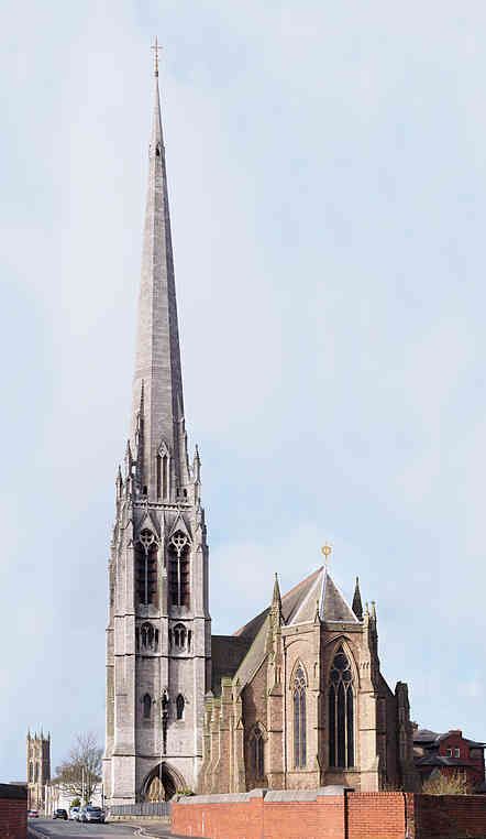 an old church with a steeple in the background