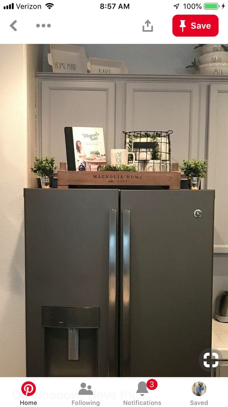 an appliance is displayed on the wall next to a refrigerator with its door open