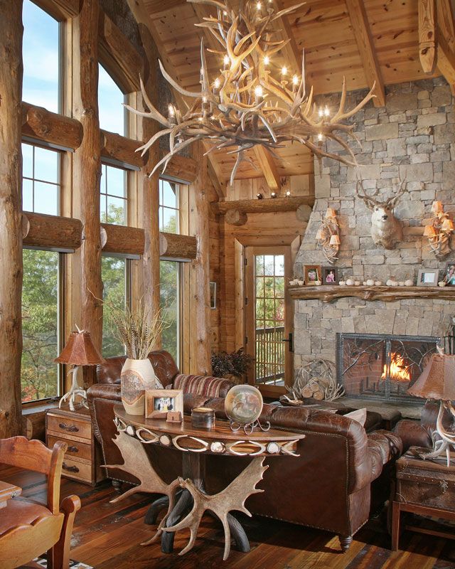 a living room filled with furniture and a fire place in the middle of a room