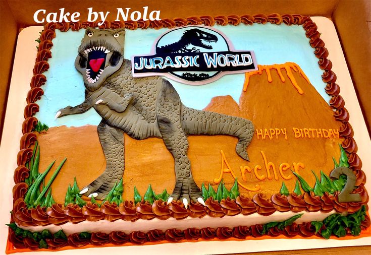 a birthday cake with an image of a dinosaur on it