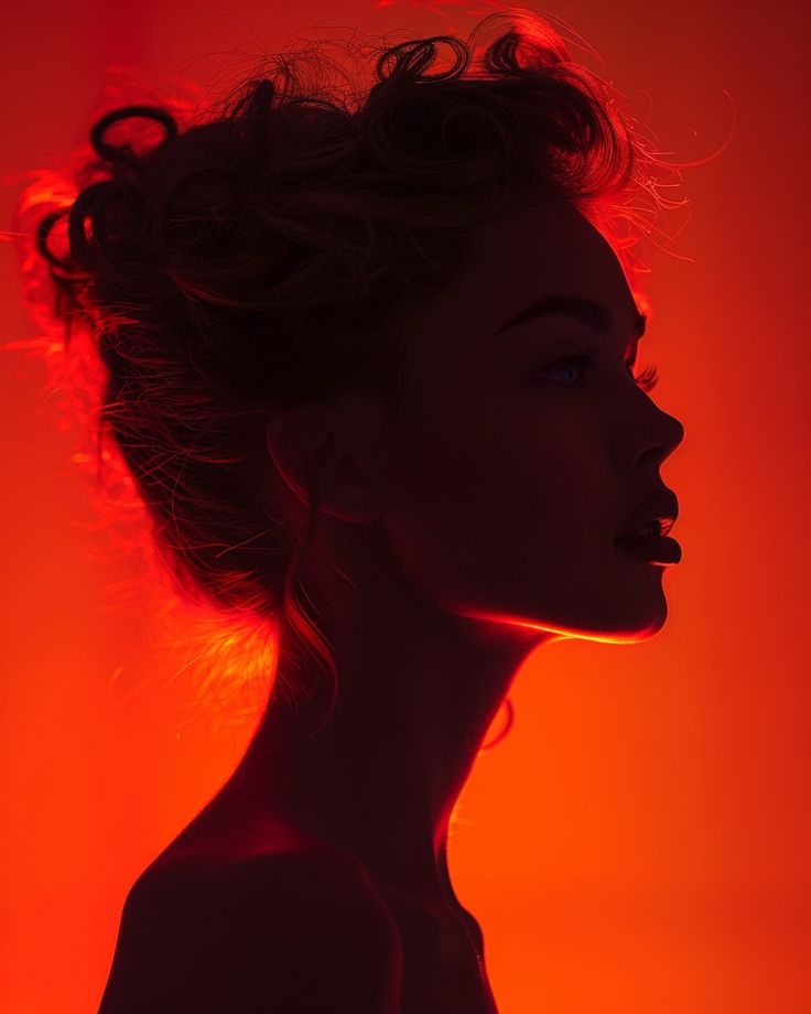 the silhouette of a woman with curly hair against an orange and red background is shown