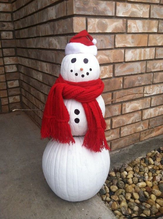 a snowman statue with a red scarf around it's neck