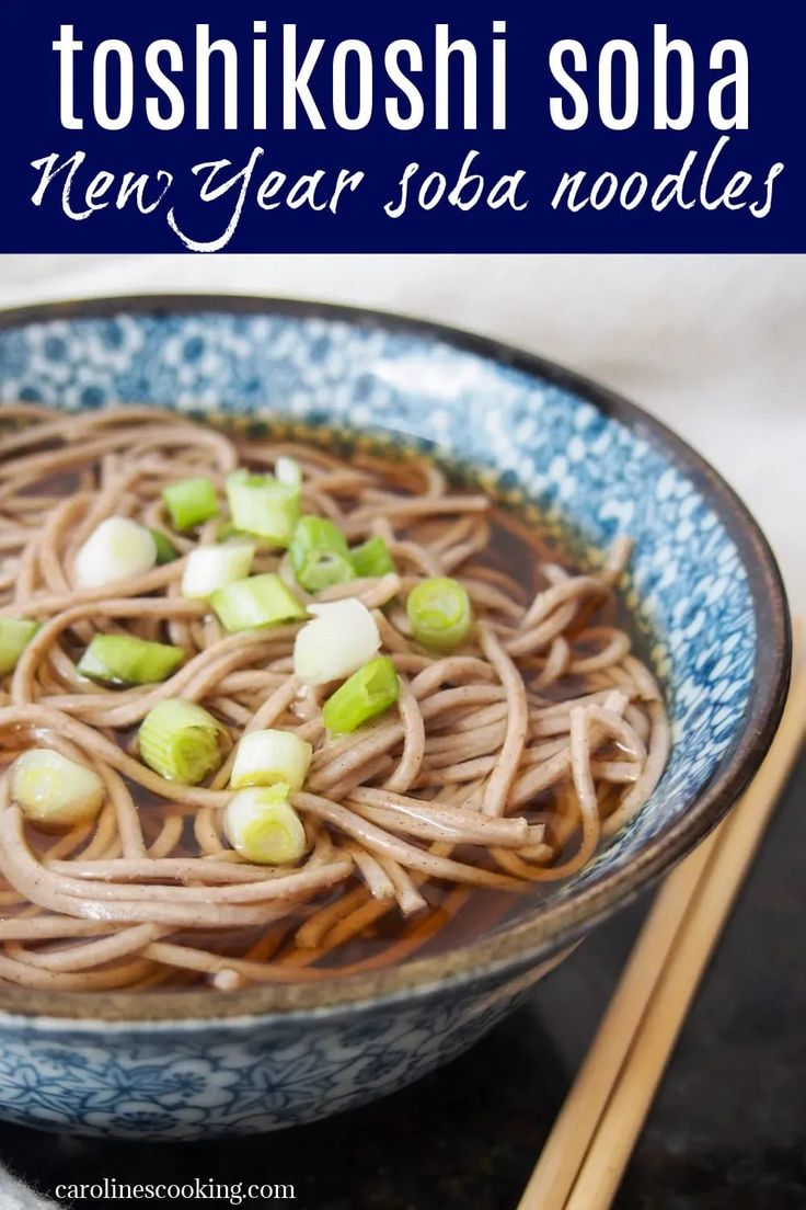 a blue bowl filled with noodles next to chopsticks