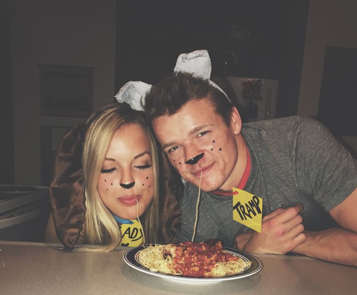 a man and woman are posing for a photo with their faces painted like people eating spaghetti