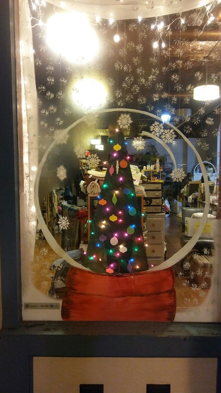 a christmas tree is in the window of a store