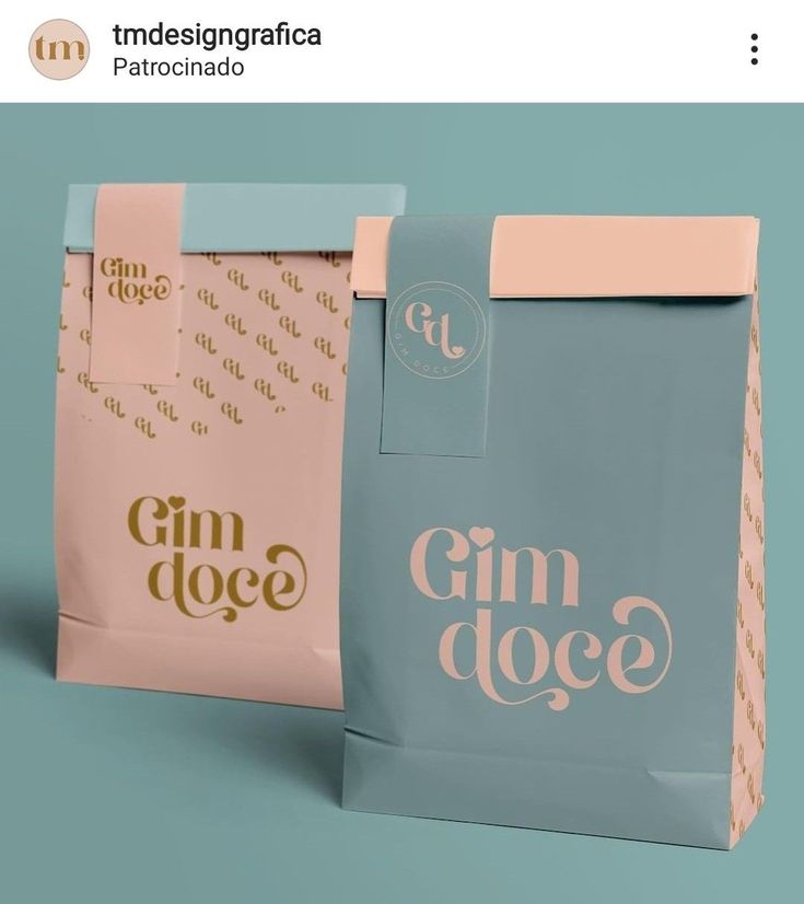 two paper bags with the words gin dole printed on them, one blue and one pink