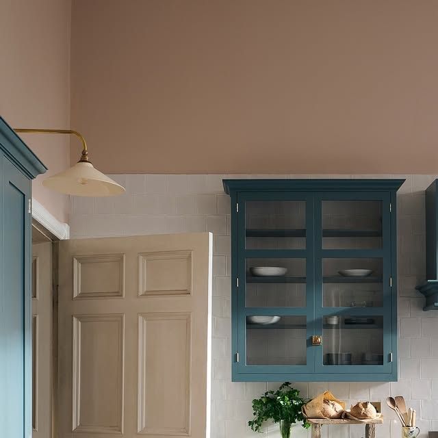 a kitchen with blue cabinets and white counter tops