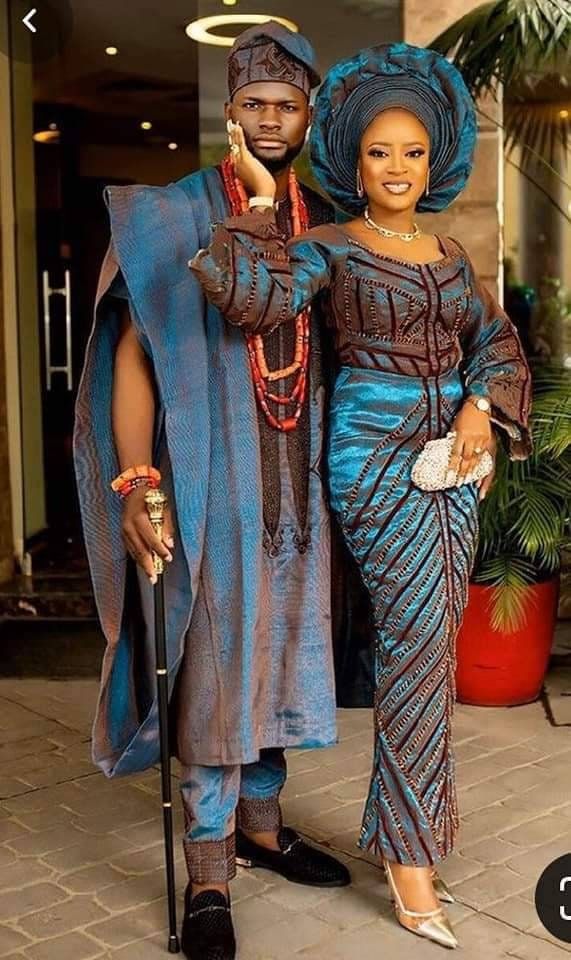 a man and woman dressed in african clothing