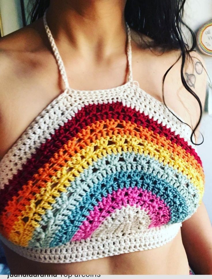 a woman wearing a multicolored crocheted halter top