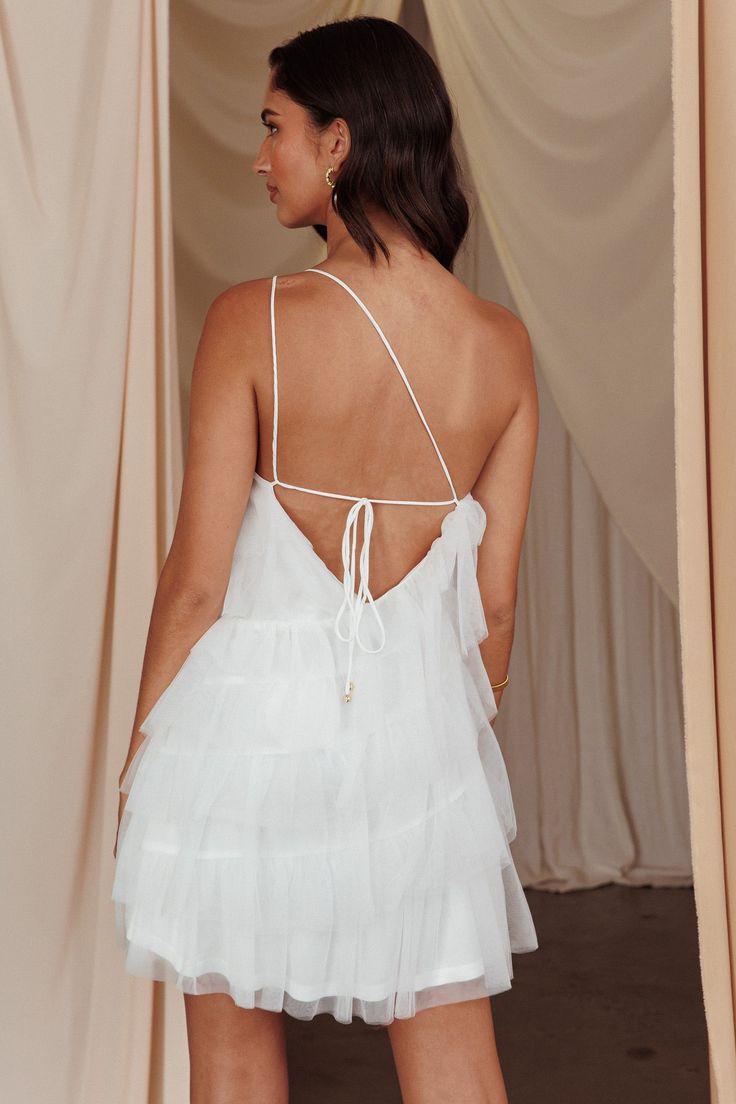 the back of a woman wearing a white dress