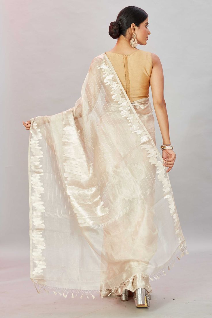 The charm of this cream tissue Banarasi sari is sure to leave everyone awestruck! It is enhanced with zari work and comes with a matching blouse piece. Disclaimer: The shown stitched blouse on the model is for display purpose only. The saree comes with a matching blouse piece and finished with fall and piko. Cream Cotton Silk Traditional Wear With Dupatta, Transitional Slub Silk Saree With Sheer Dupatta, Elegant Cream Cotton Silk Traditional Wear, Off-white Cotton Silk Traditional Wear For Transitional Season, Wedding Cream Slub Silk Dupatta, Beige Dupatta For Diwali, Festive Cream Cotton Silk Traditional Wear, Off White Tissue Silk Traditional Wear With Dupatta, Cream Slub Silk Traditional Wear With Dupatta