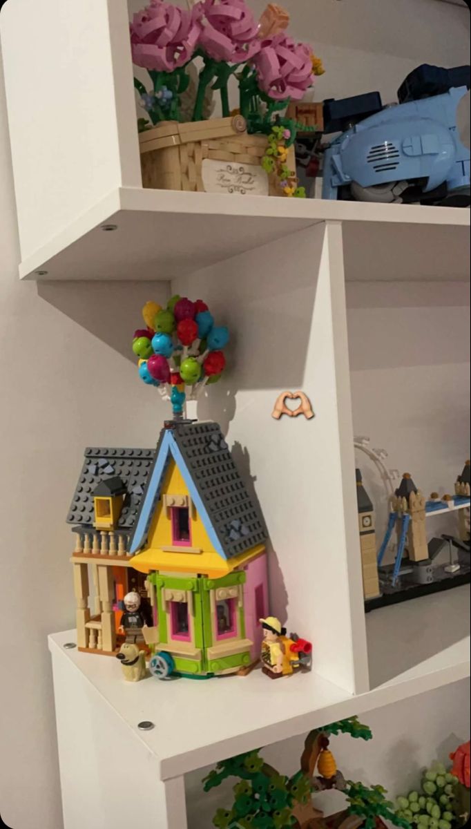 a toy house is on top of a shelf