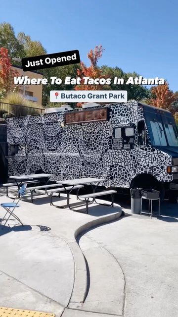 the food truck is decorated with black and white spots