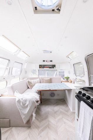 the inside of a camper with an oven and couch