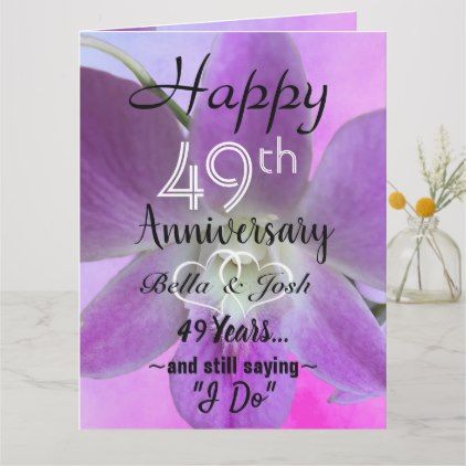 an anniversary card with purple flowers and hearts