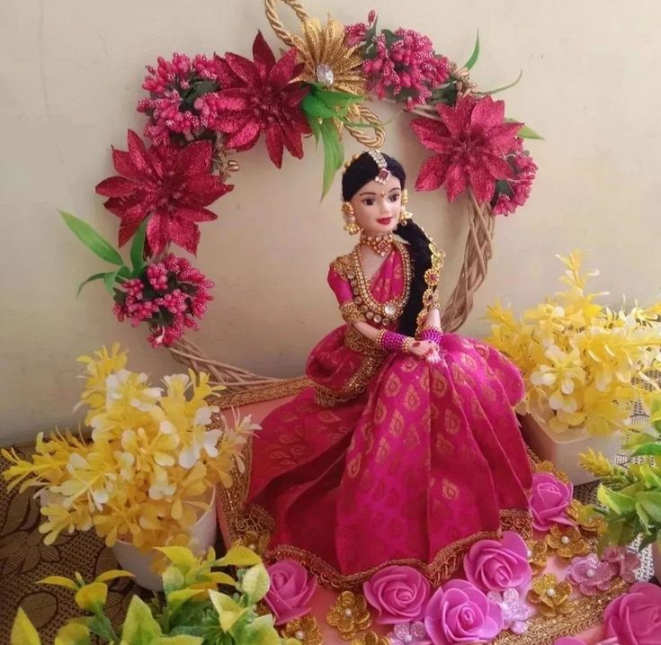 a doll sitting on top of a table surrounded by flowers